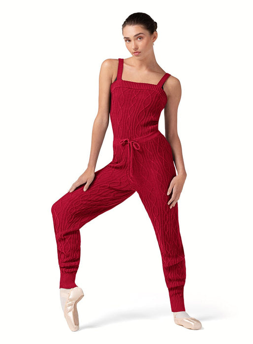 Woman wearing a red ribbed jumpsuit on a white background
