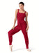 Woman wearing a red ribbed jumpsuit on a white background