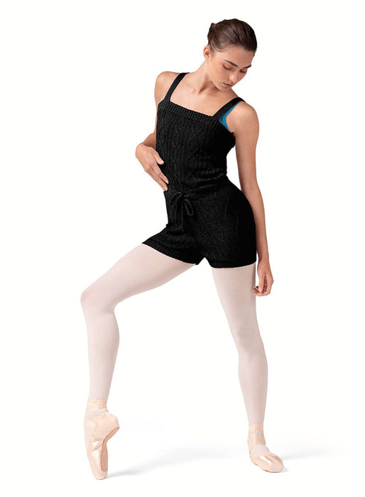 Dancer in a black leotard and tights on a white background