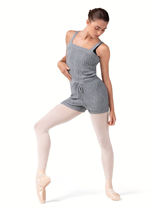Dancer in a gray romper with white tights on a white background