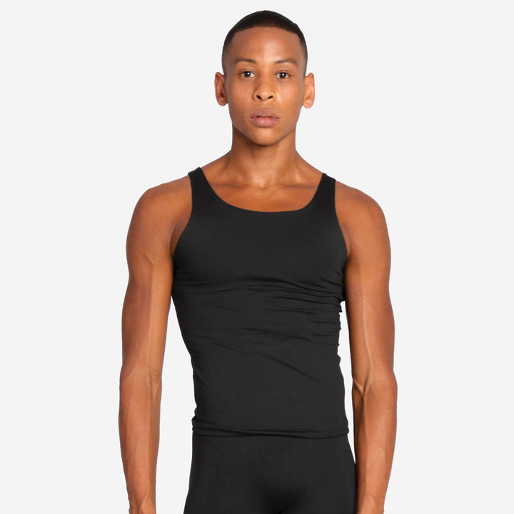 Person wearing a black tank top on a plain background