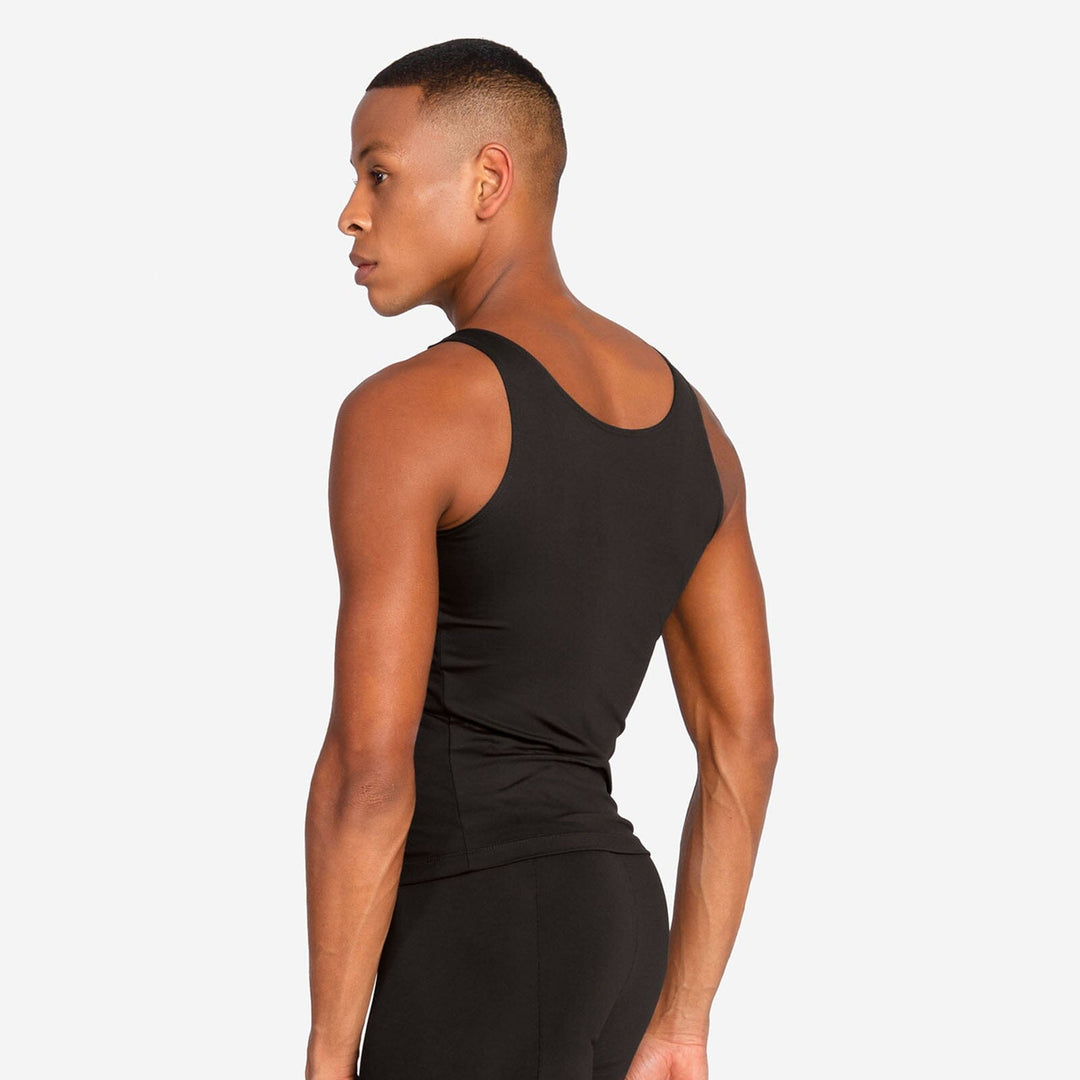 Person wearing a black tank top and shorts on a white background