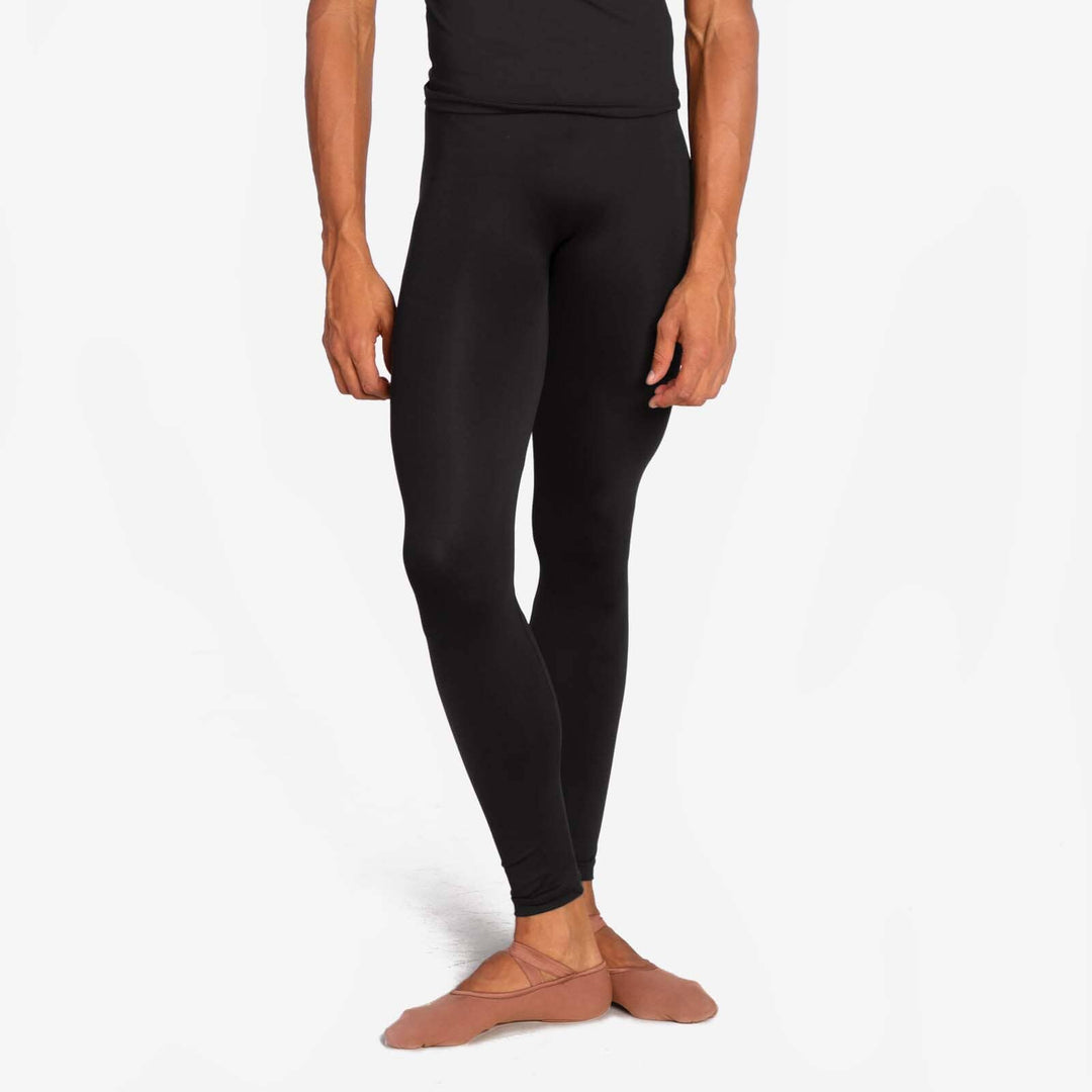 Person wearing black leggings on a white background