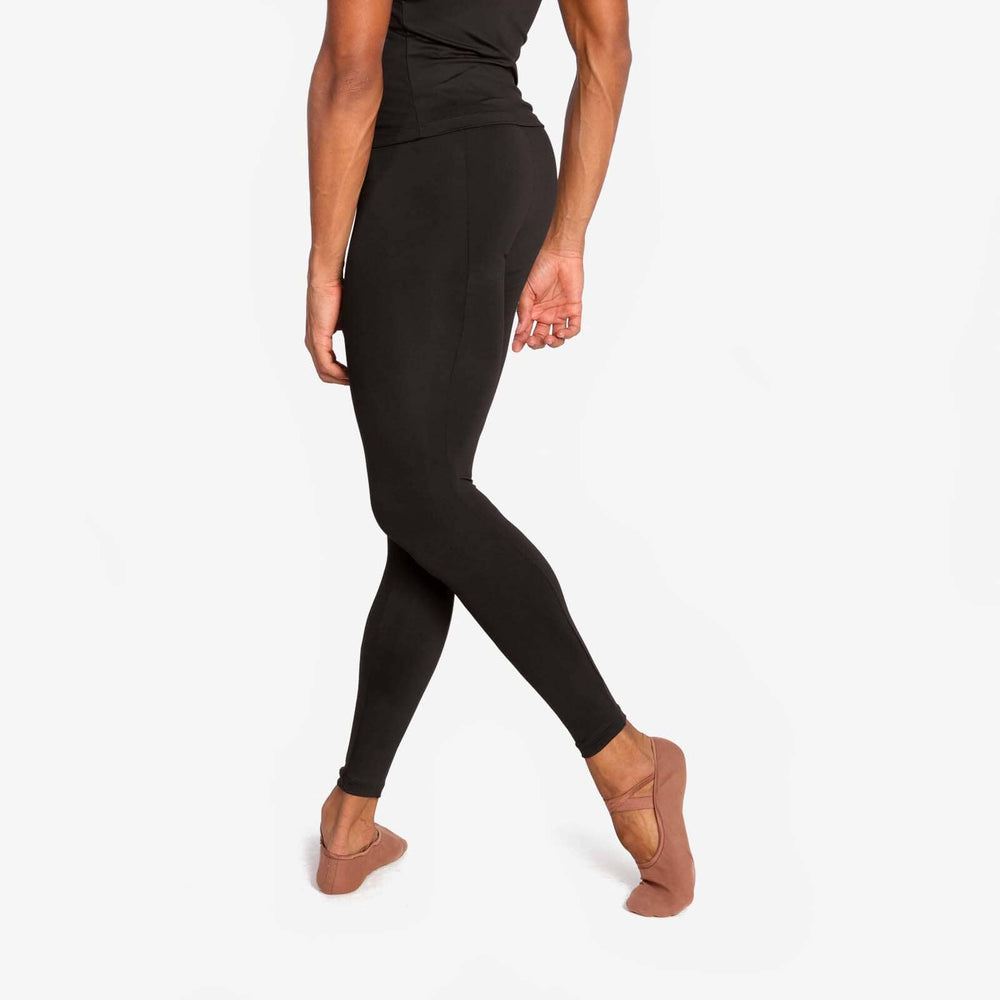 Person wearing black leggings on a white background