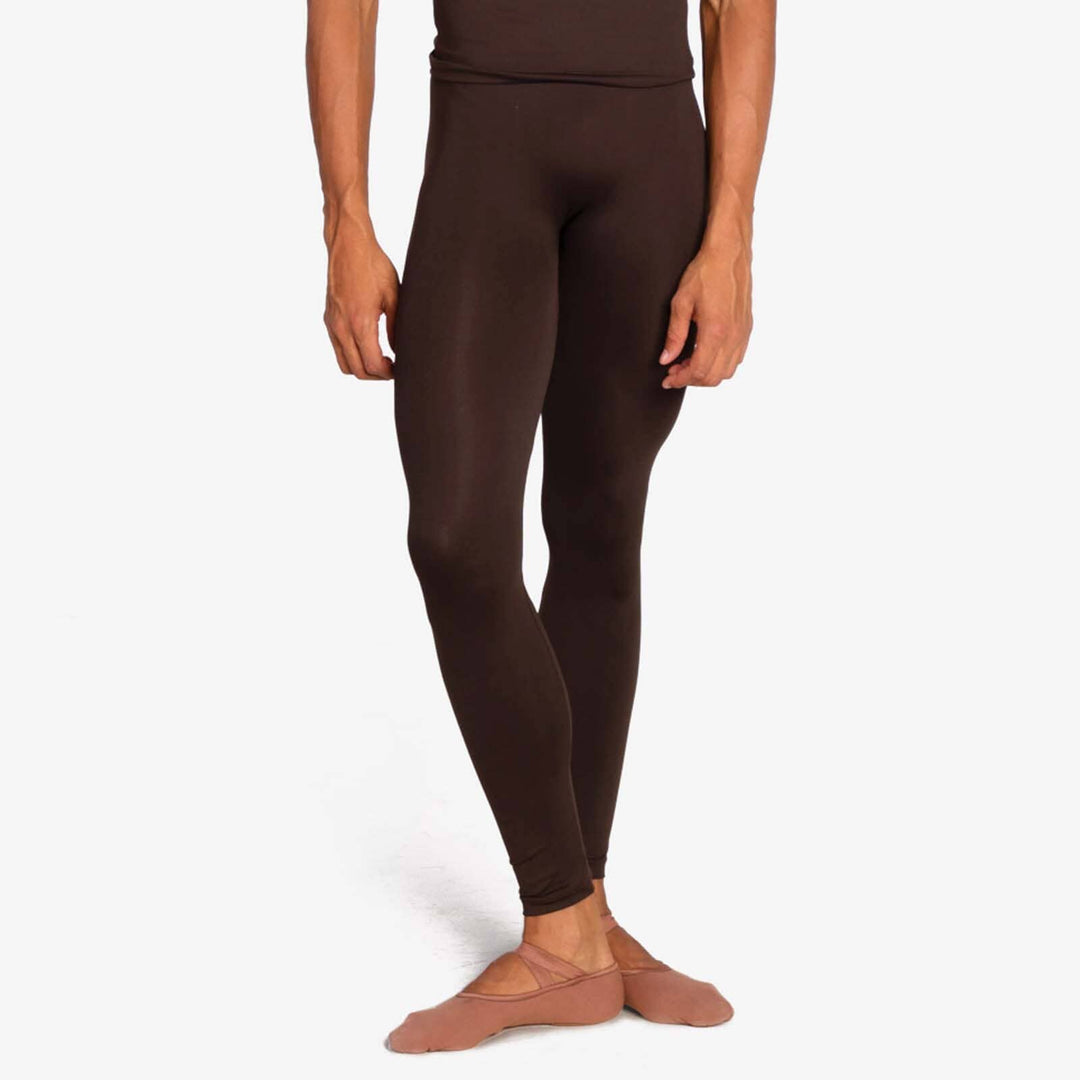 Person wearing brown leggings on a white background