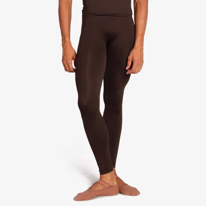 Person wearing brown leggings on a white background