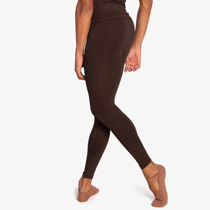 Person wearing brown leggings on a white background