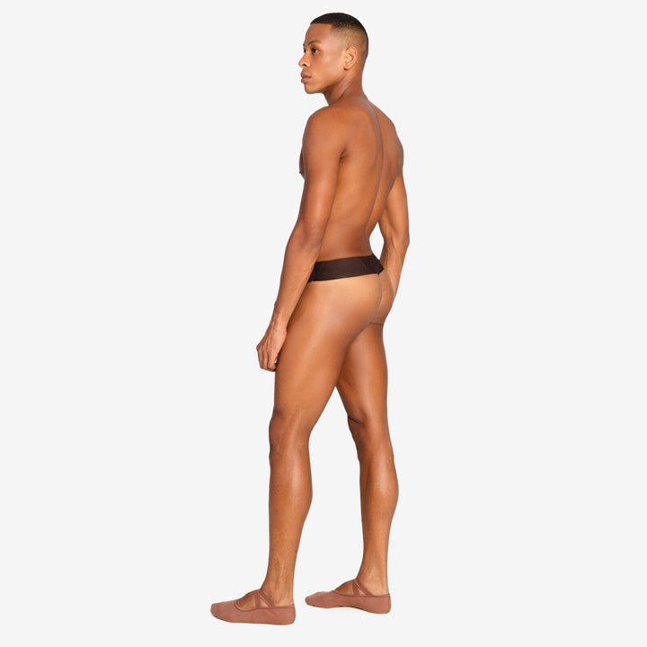 Man wearing a black thong on a white background