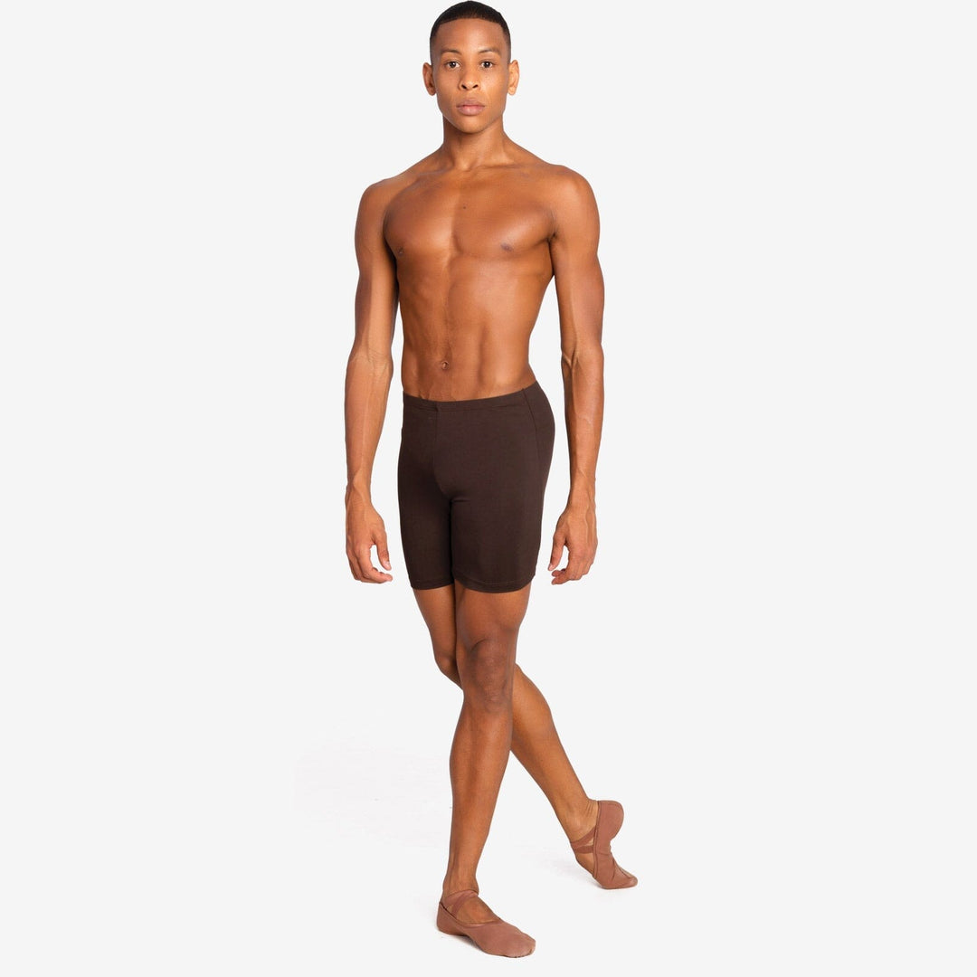 Man wearing brown swim shorts on a white background