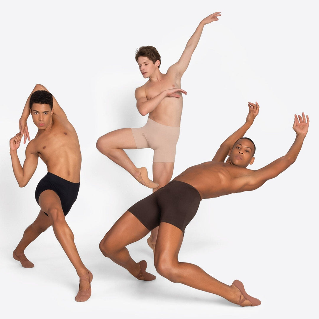 Three dancers in black, beige, and brown underwear posing against a white background