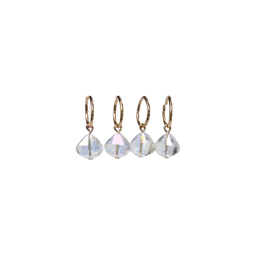 Set of four gold hoop earrings with clear gemstones on a white background