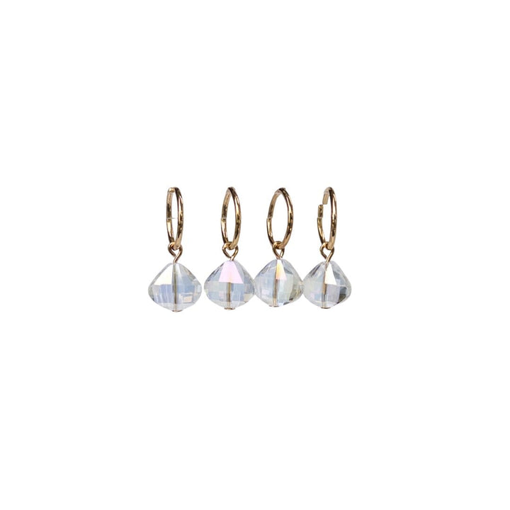 Set of four gold hoop earrings with clear gemstones on a white background