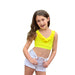 Young girl wearing a yellow top and white shorts on a white background
