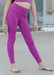 Person wearing bright purple leggings outdoors on a neutral background
