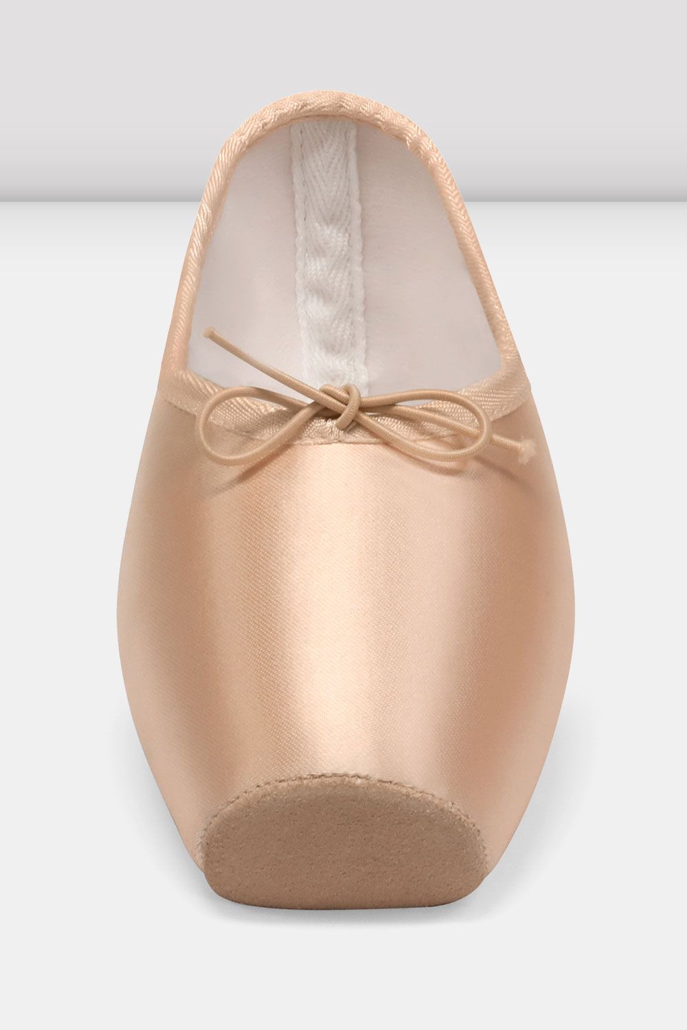 Ballet shoe with a bow on a light gray background