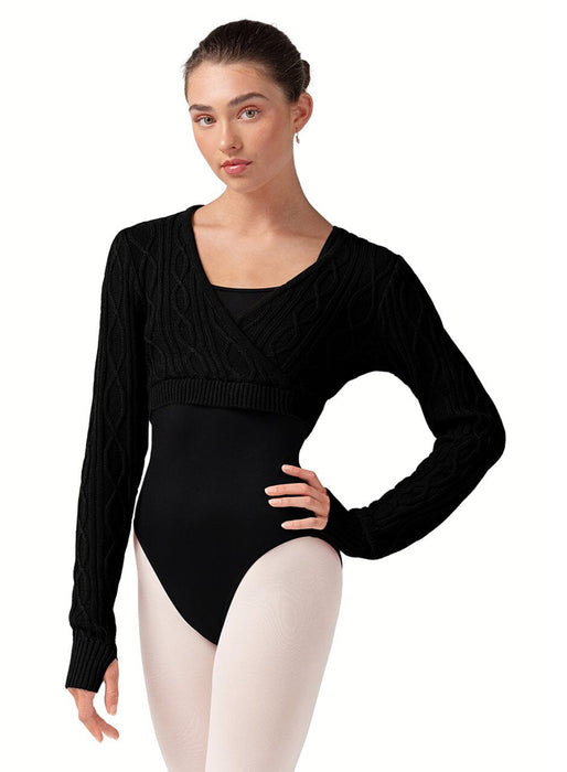 Woman wearing a black long-sleeve leotard with a textured top on a white background