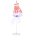 Decorative candle shaped like a pink dress with a purple bow on a white background
