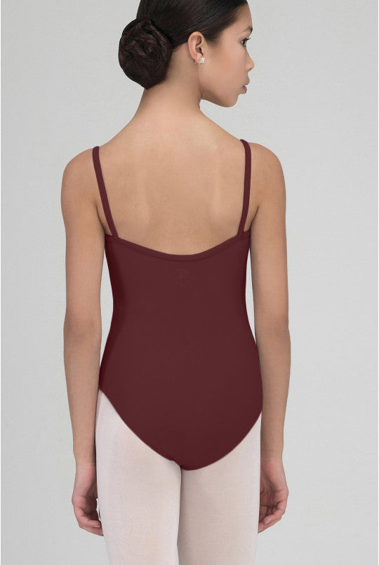 Ballerina wearing a burgundy leotard on a plain background