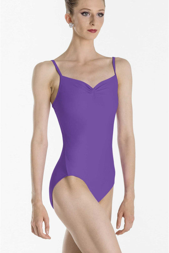 Woman wearing a purple leotard on a white background
