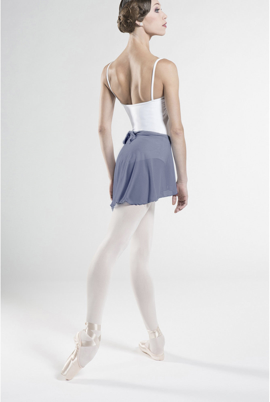 Ballerina in a white top and blue skirt on a white background