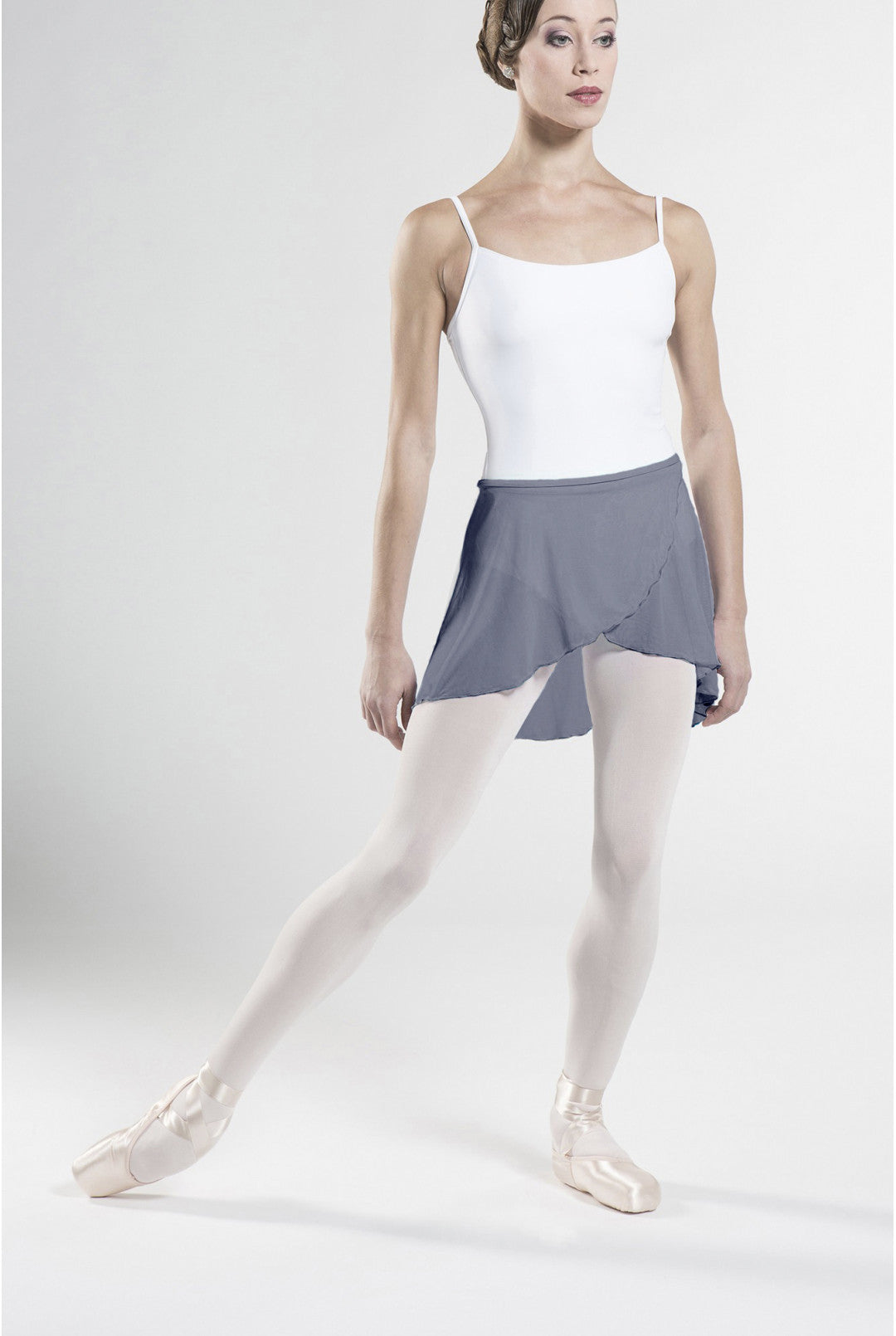 Ballerina in a white top and gray skirt on a white background