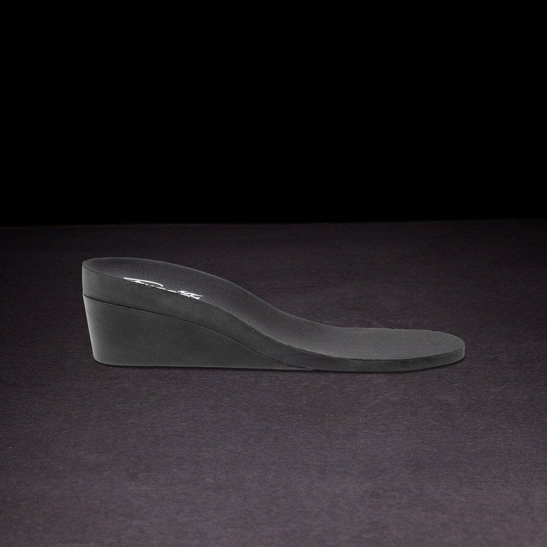 Black wedge shoe on a dark background