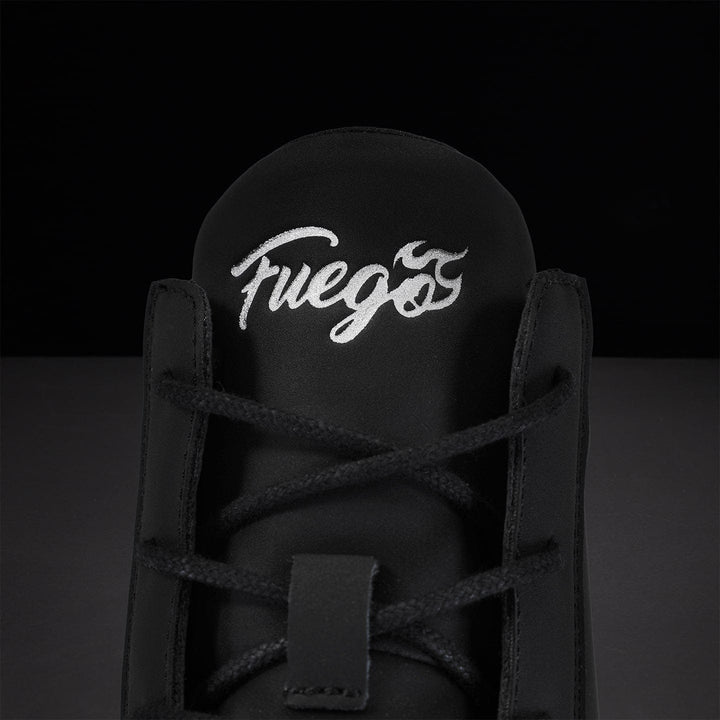Black sneaker with white 'Fuego' logo on the back against a dark background.