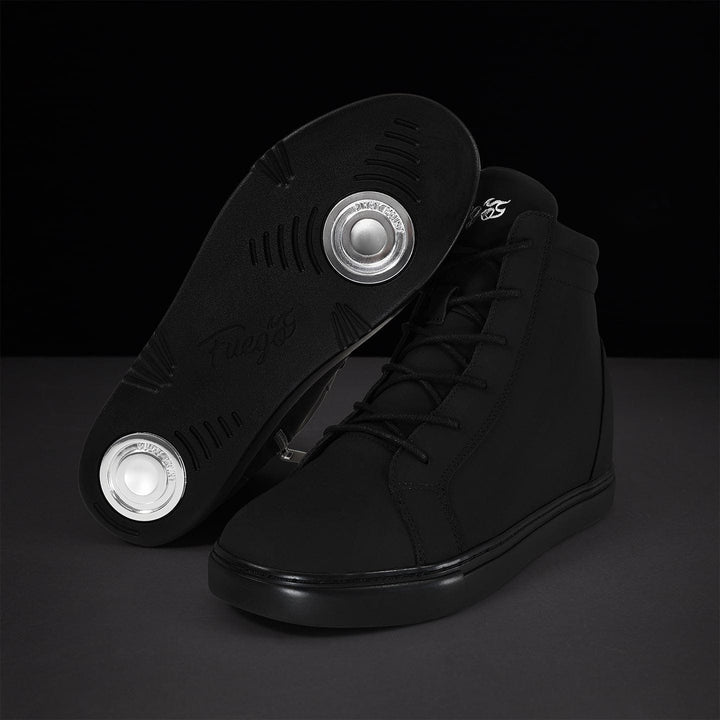 A pair of all-black high-top wedge sneakers with silver accents, showcasing the sole and side profile on a dark background.