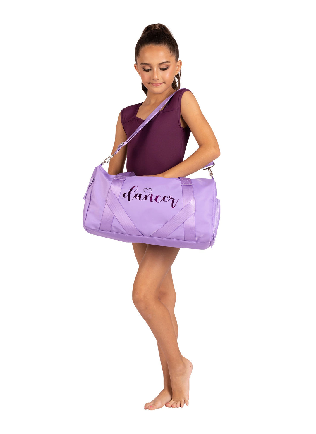 Girl holding a purple dance bag with 'dancer' written on it against a white background
