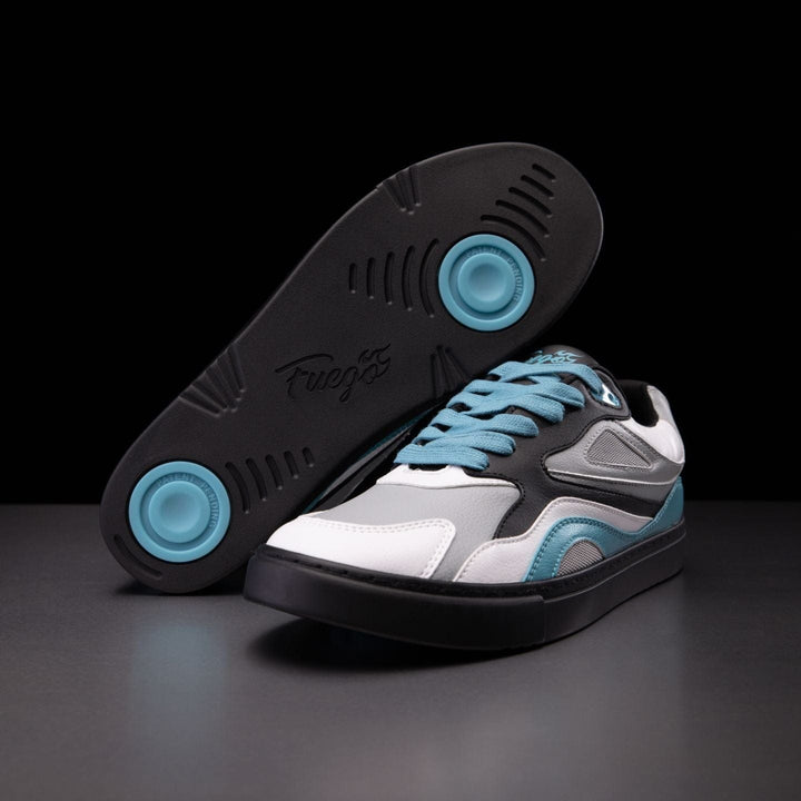 A pair of dance sneakers with black, white, and blue colors, showcasing the sole with blue traction patterns and ventilated air holes from above.