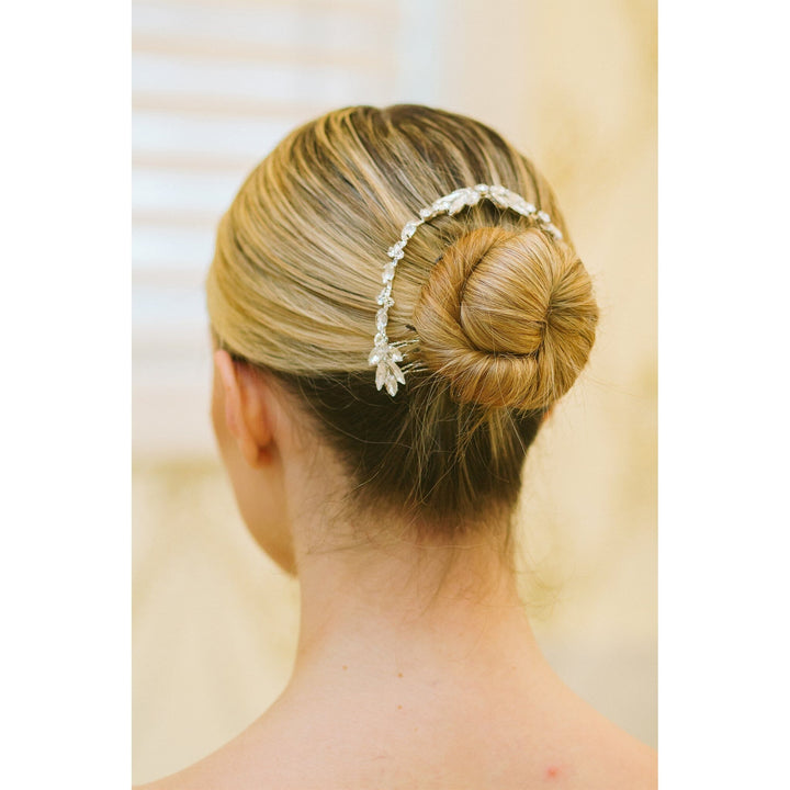 Hair bun with a decorative headband on a neutral background