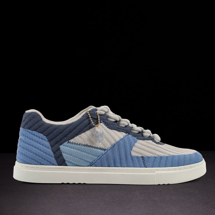Blue and gray sneaker on a black background