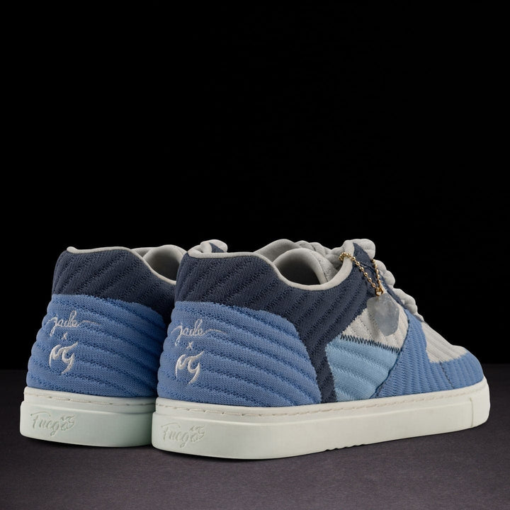 Blue and gray sneakers with branding on a black background