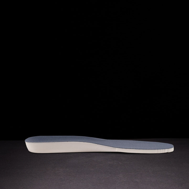 Shoe insole with blue and white design on a black background