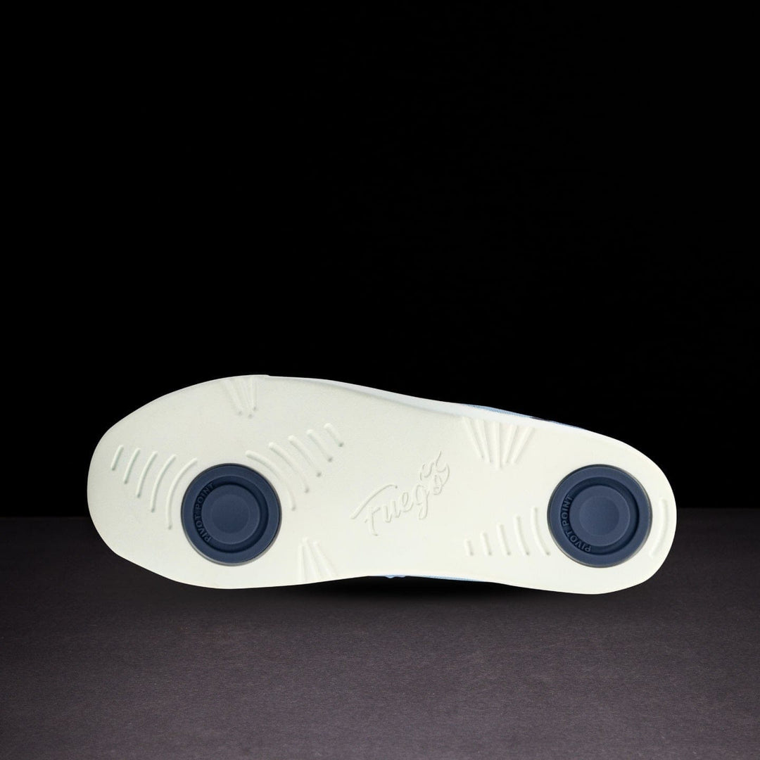 White shoe sole with blue accents on a black background