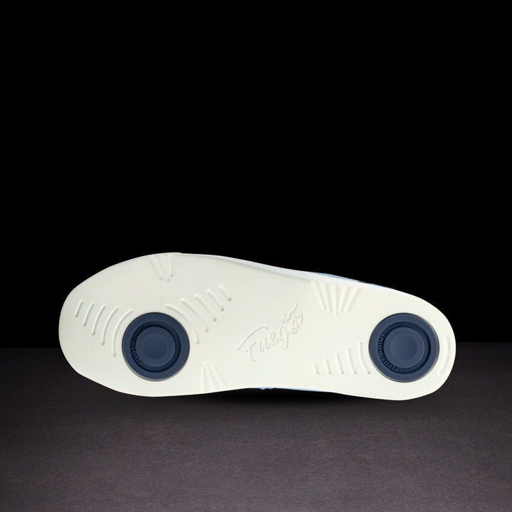 White shoe sole with blue accents on a black background