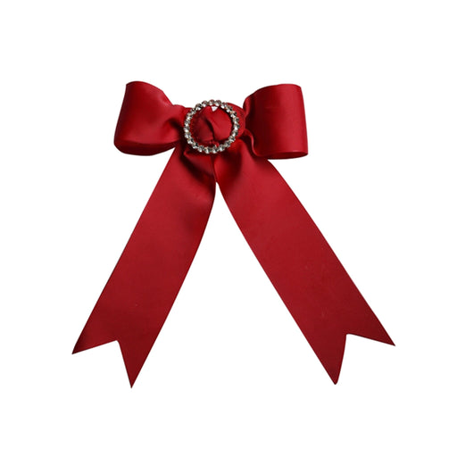 Red bow with a decorative brooch on a white background