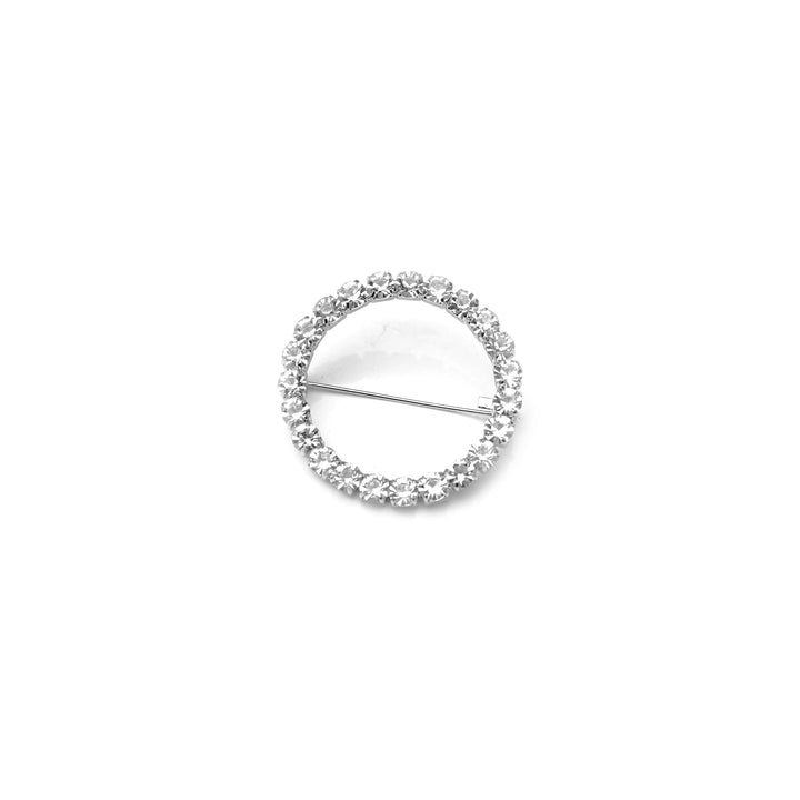 Silver brooch with clear gemstones on a white background