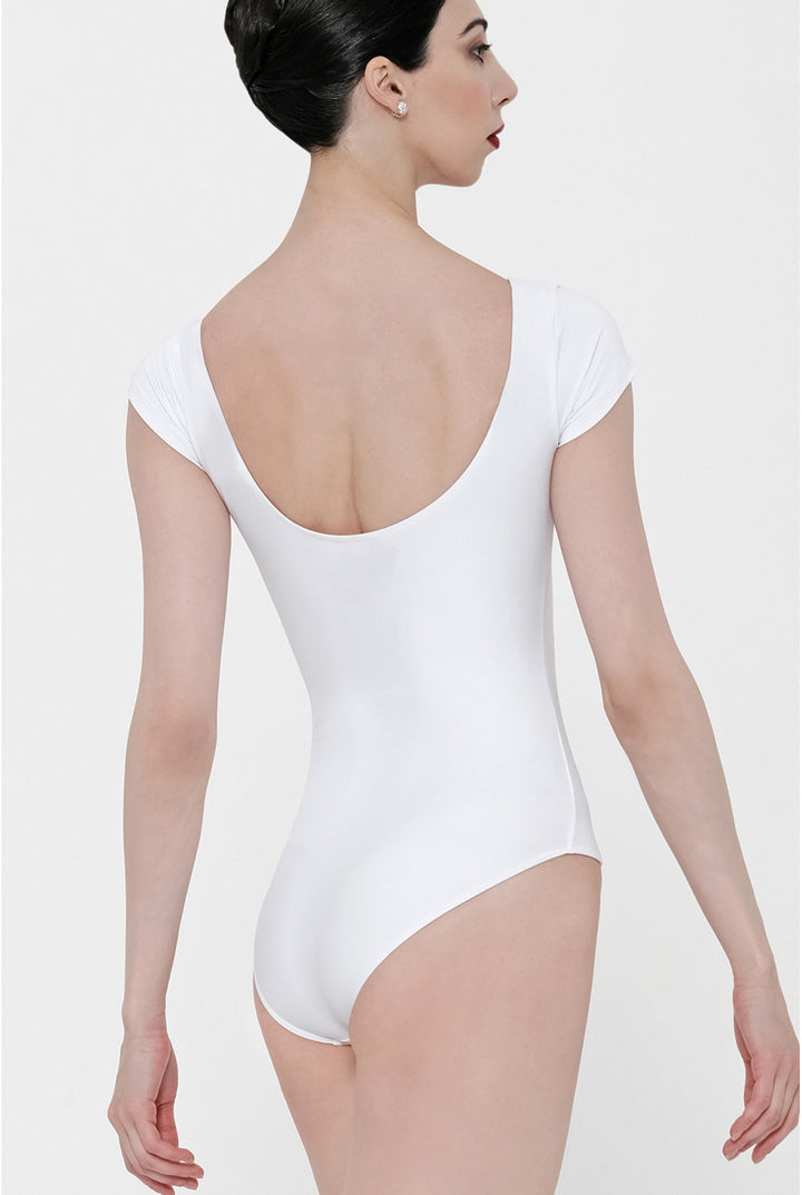 A woman shown from the back wearing a white short-sleeve bodysuit with a deep scoop neckline, photographed against a plain light gray studio background.