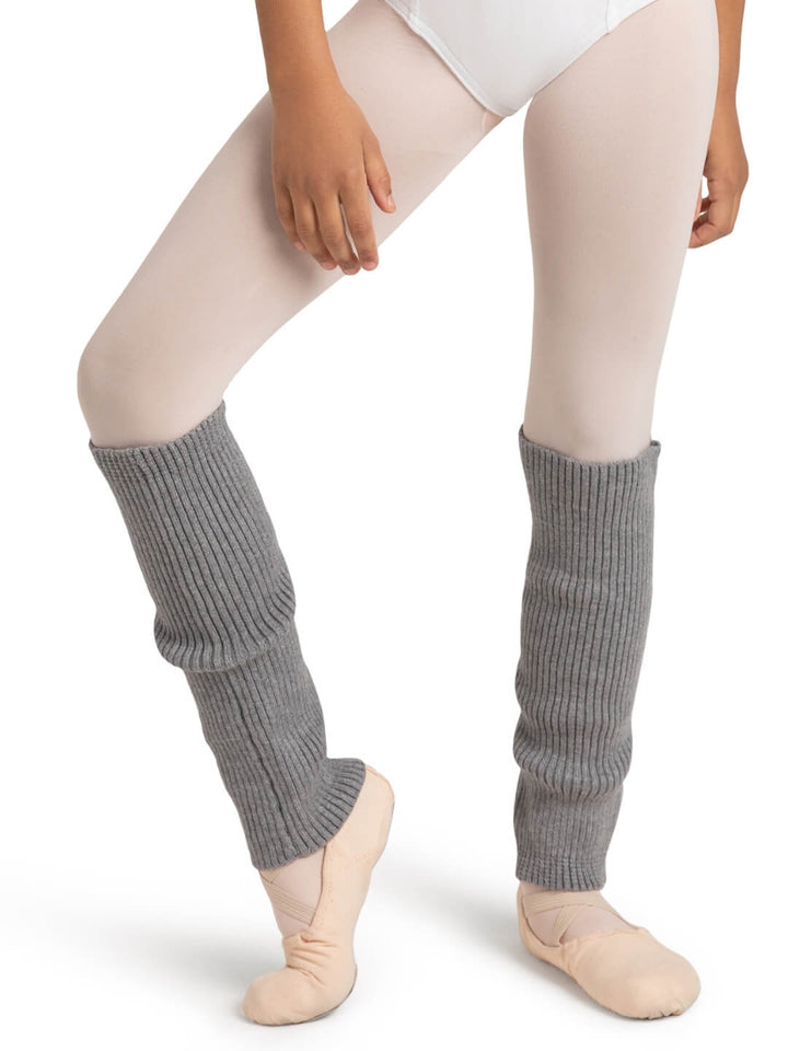 Person wearing gray ribbed leg warmers on a white background