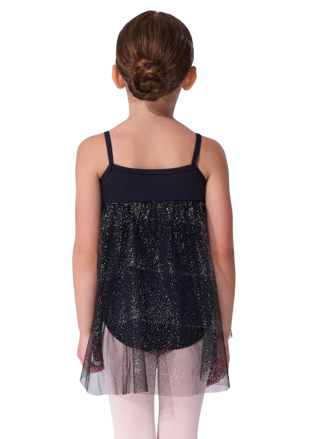 Young girl wearing a black sequin dress with sheer overlay on a white background
