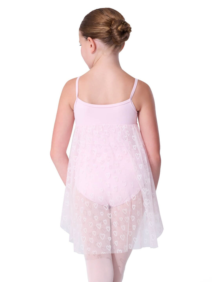 Young girl wearing a light pink floral dress on a white background