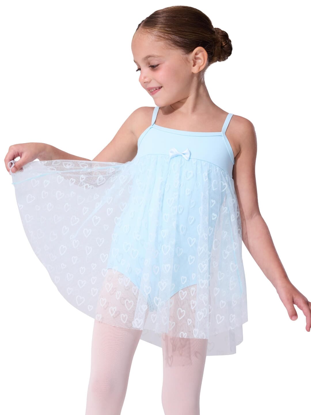 Young girl wearing a light blue ballet dress with a white lace overlay on a white background