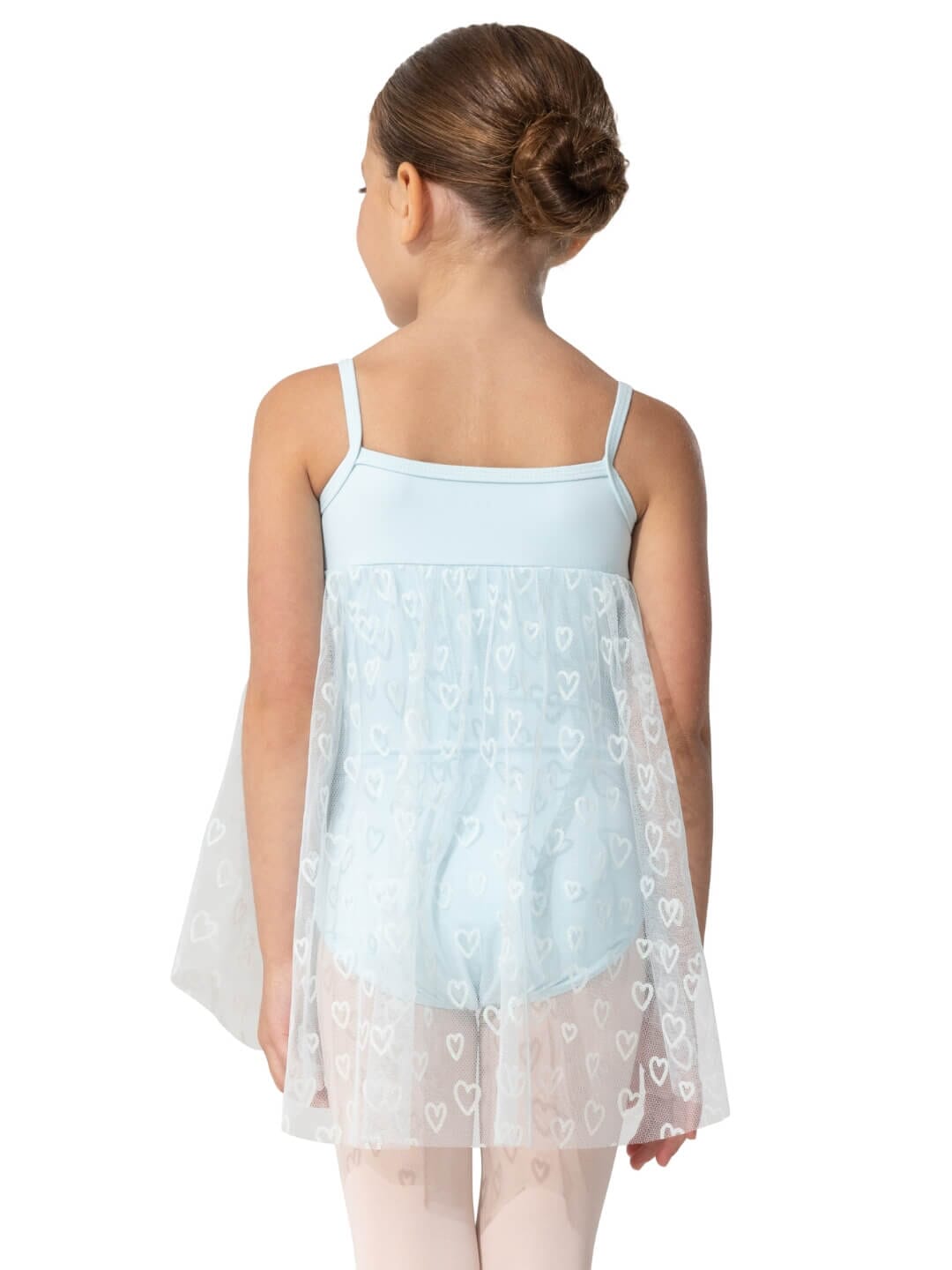 Girl wearing a light blue dress with a heart pattern on a white background