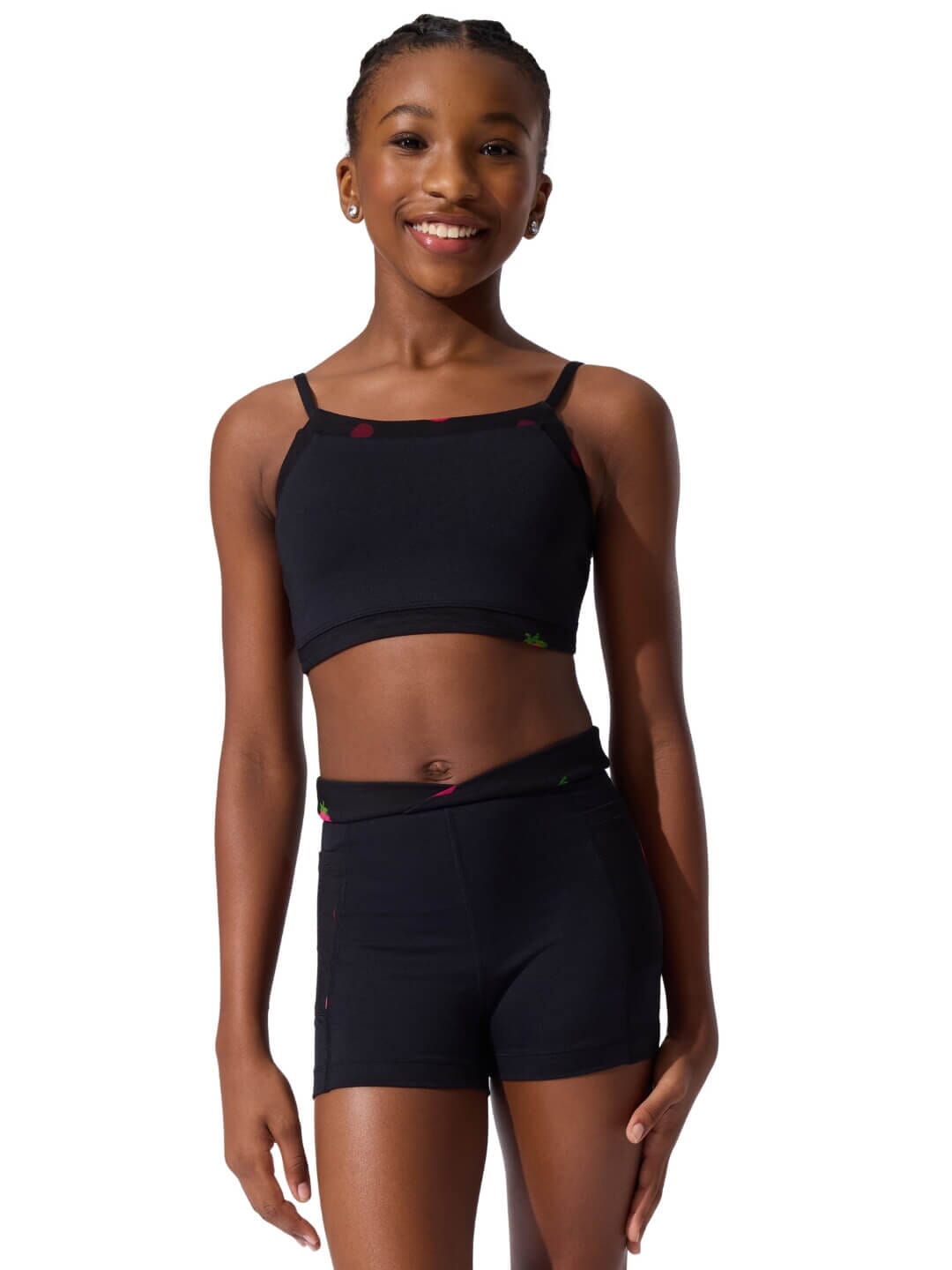 Woman wearing a black sports bra and shorts on a white background