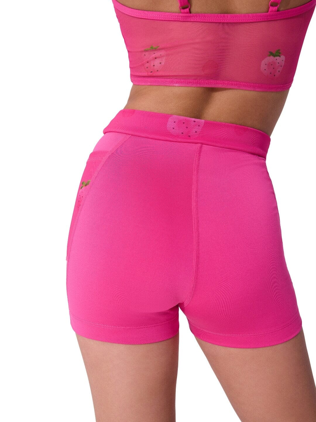 Pink athletic shorts with a matching sports bra on a white background