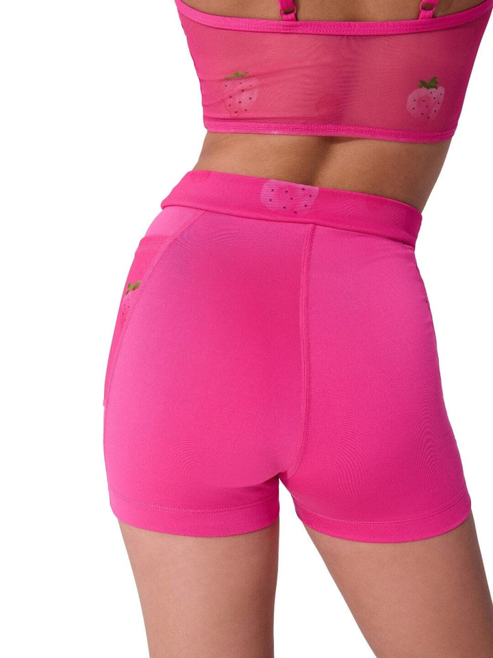 Pink athletic shorts with a matching sports bra on a white background