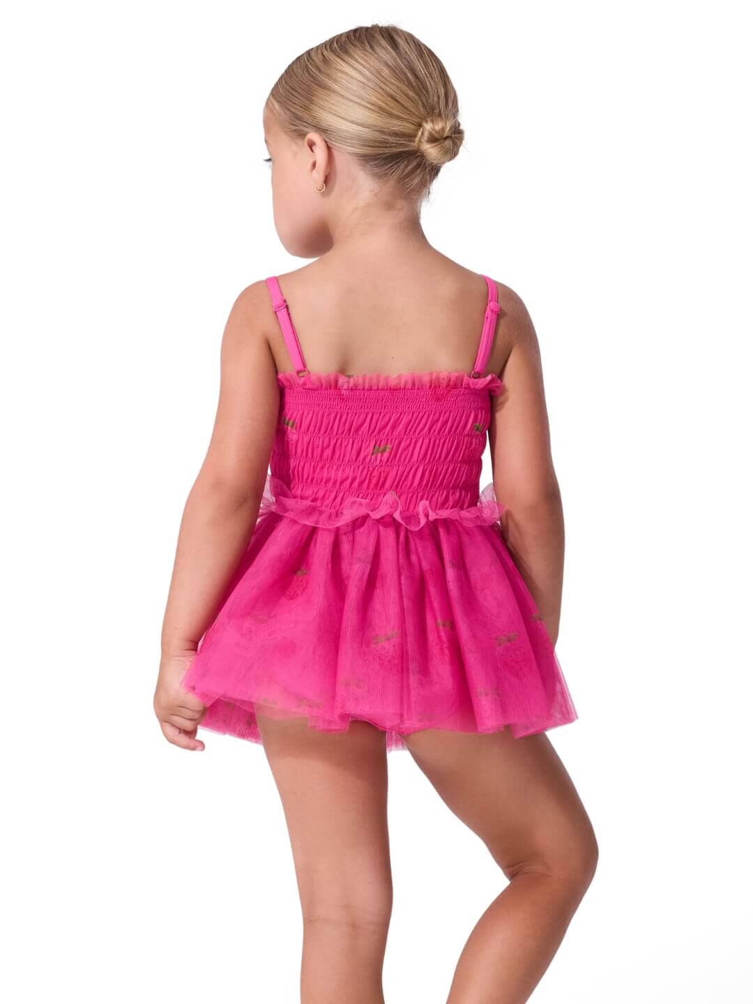Young girl wearing a pink dress on a white background