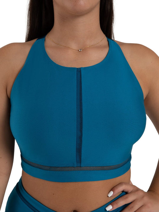 Teal sports bra with mesh panels on a white background