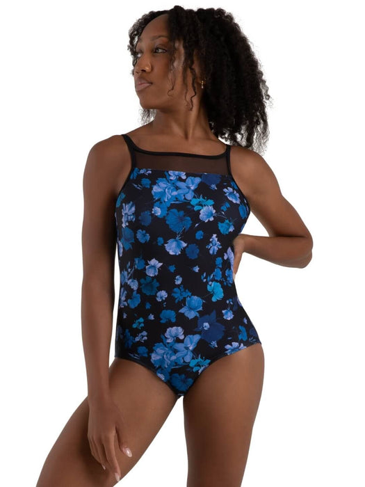 Woman wearing a black swimsuit with blue floral pattern on a white background